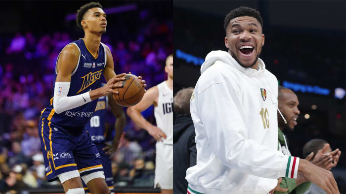 Victor Wembanyama shoots a free-throw, while Giannis Antetokounmpo laughs